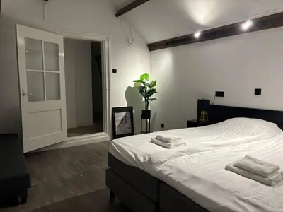 a bedroom with a bed with two towels on it at Luxury 6pers appartement Abcoude in Abcoude