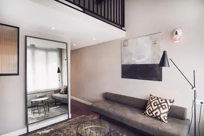 a living room with a couch and a mirror at Morgan & Mees Amsterdam in Amsterdam
