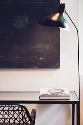 a black lamp sitting on top of a desk at Morgan & Mees Amsterdam in Amsterdam
