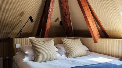 a bed with two pillows on it in a room at Morgan & Mees Amsterdam in Amsterdam