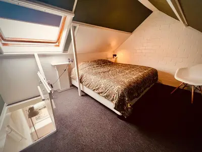 a bedroom with a bed in a attic at Aan de dijk in Dirkshorn
