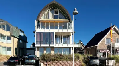 a large white building with a large window at Sterrenlicht by Droomvilla in Egmond aan Zee