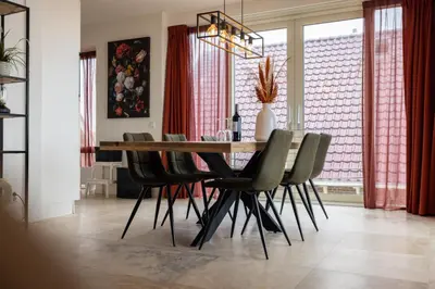 a dining room with a table and chairs at Sterrenlicht by Droomvilla in Egmond aan Zee