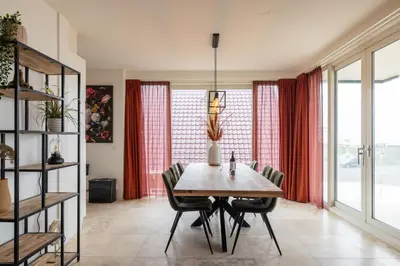 a dining room with a table and chairs at Sterrenlicht by Droomvilla in Egmond aan Zee