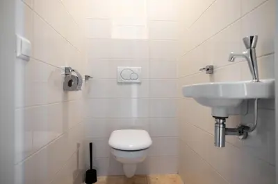 a bathroom with a toilet and a sink at Zilverlicht by Droomvilla in Egmond aan Zee