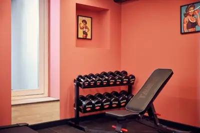 a room with a gym with a rack of dumbbells at The Elephant Hostel in Amsterdam
