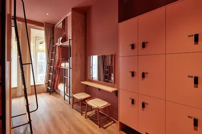 a room with red cabinets and a ladder and a stool at The Elephant Hostel in Amsterdam