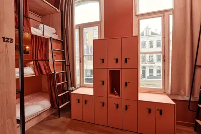 a room with bunk beds and a window at The Elephant Hostel in Amsterdam