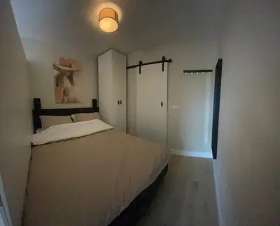 a bedroom with a large bed and a closet at Joysea Appartments in Zandvoort