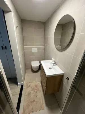 a bathroom with a sink and a toilet and a mirror at Joysea Appartments in Zandvoort