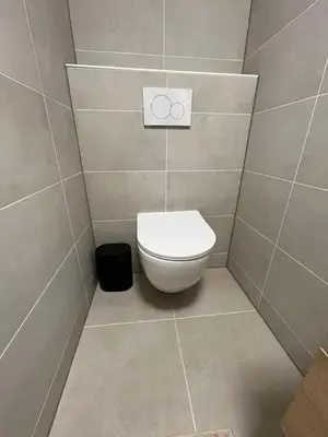 a bathroom with a white toilet in a room at Joysea Appartments in Zandvoort
