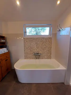 a large bath tub in a bathroom with a window at BB-4u in IJsselstein
