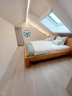 a bedroom with a large bed with a skylight at BB-4u in IJsselstein