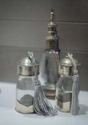 two glass jars with tassels are sitting on a table at M-Square in Amsterdam