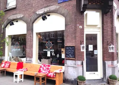 a store with a bench in front of a building at M-Square in Amsterdam