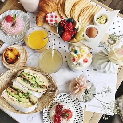 a table topped with plates of food and pastries at M-Square in Amsterdam