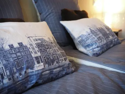 a bed with two pillows on top of it at M-Square in Amsterdam