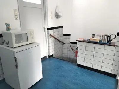 a kitchen with a microwave on top of a refrigerator at Historic canal house in green residential area in Utrecht