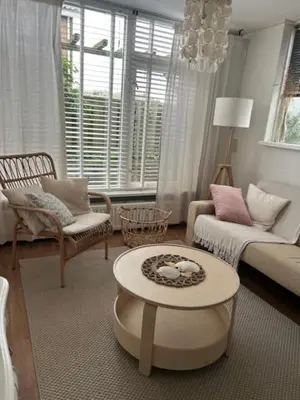 a living room with a couch and a table at BeJa bij strand en duin in Egmond aan Zee