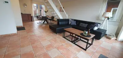 a living room with a couch and a table at Appartement Uniekappart in Uitgeest