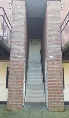 a stairway leading into a brick building with stairs at Appartement Uniekappart in Uitgeest