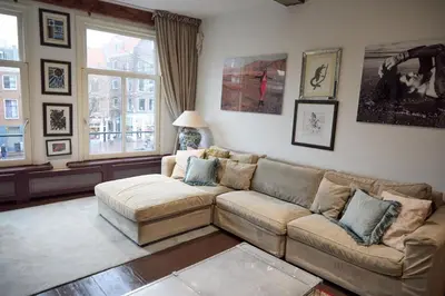 a living room with a couch and a window at redlight canalview city centre in Amsterdam