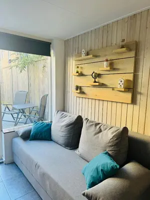a living room with a couch and a patio at Beachhouse R&M in Noordwijk aan Zee