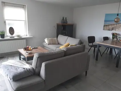 a living room with a couch and a table at Atlantis 16b in Egmond aan Zee