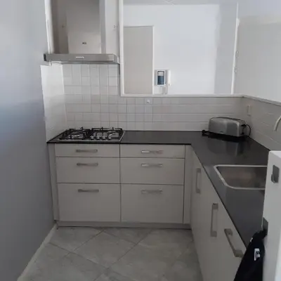 a kitchen with a sink and a stove top oven at Atlantis 16b in Egmond aan Zee