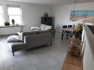a living room with a couch and a table at Atlantis 16b in Egmond aan Zee