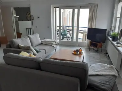 a living room with a couch and a table at Atlantis 16b in Egmond aan Zee