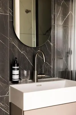 a bathroom with a sink and a mirror at THE FRITZ Hotel Amsterdam in Amsterdam