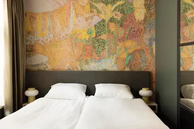 a bedroom with two white beds and a painting at THE FRITZ Hotel Amsterdam in Amsterdam