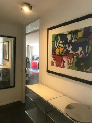 a living room with a painting on the wall at Meerblick Atlantis 17 c in Egmond aan Zee