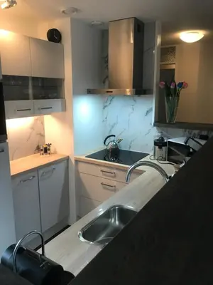 a kitchen with a sink and a counter top at Meerblick Atlantis 17 c in Egmond aan Zee