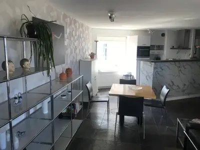 a kitchen with a table and a dining room at Meerblick Atlantis 17 c in Egmond aan Zee