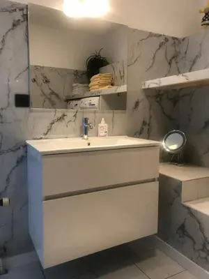 a bathroom with a sink and a mirror at Meerblick Atlantis 17 c in Egmond aan Zee