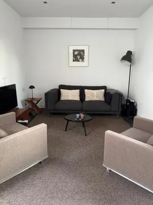 a living room with a couch and a table at Luxury semi-detached house near Amsterdam in Loenen aan de Vecht