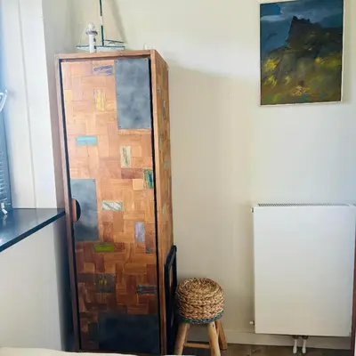 a wooden door in a room with a stool at Villa Happy Days in Egmond aan Zee