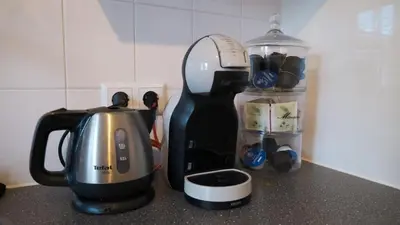 a kitchen counter with a coffee maker and a blender at 't Sand Apartment in Zandvoort