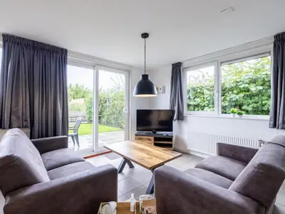 a living room with two couches and a table at Waterlelie Vakantiepark De Groote Vliet in Wervershoof