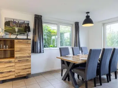 a dining room with a wooden table and blue chairs at Waterlelie Vakantiepark De Groote Vliet in Wervershoof