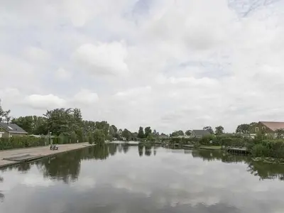 a view of a river with a cloudy sky at Wilgenroos Vakantiepark De Groote Vliet in Wervershoof