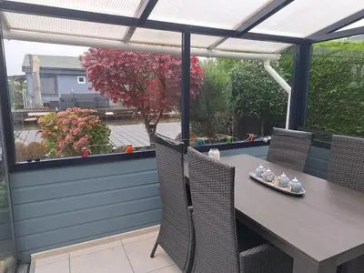 a table and chairs on a patio with a pergola at Bungalow in Wervershoof with 1 bedroom in Wervershoof