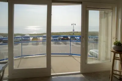 a sliding glass door with a view of a balcony at Atlantis 14 in Egmond aan Zee