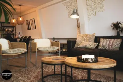 a living room with a couch and tables and chairs at Atlantis 18 in Egmond aan Zee