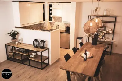 a living room with a table and a kitchen at Atlantis 18 in Egmond aan Zee