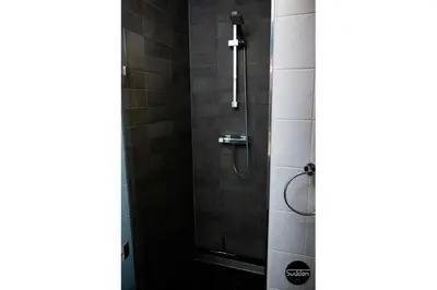 a bathroom with a shower with a glass door at Atlantis 18 in Egmond aan Zee
