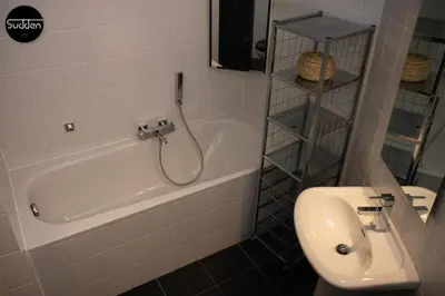 a bathroom with a white tub and a sink at Atlantis 18 in Egmond aan Zee