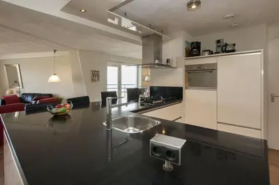 a kitchen with a sink and a counter top at Atlantis 19a in Egmond aan Zee